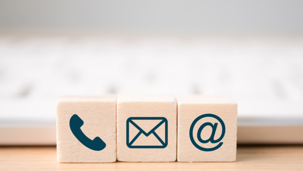 Kontaktformular Drei Holzwürfel mit Icons drauf liegen vor einer Tastatur